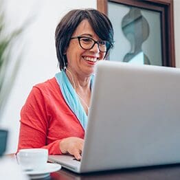 Mature woman using pc laptop indoor