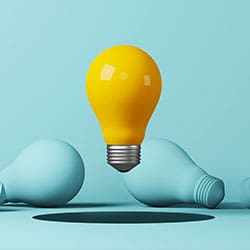 Light bulb yellow floating outstanding among lightbulb light blue on background. Concept of creative idea and innovation